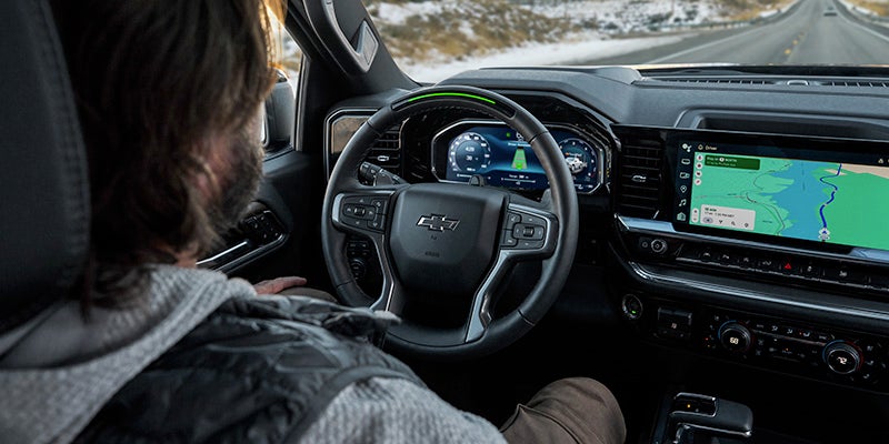 Chevy silverado interior with driver, dashboard, and navigation screen